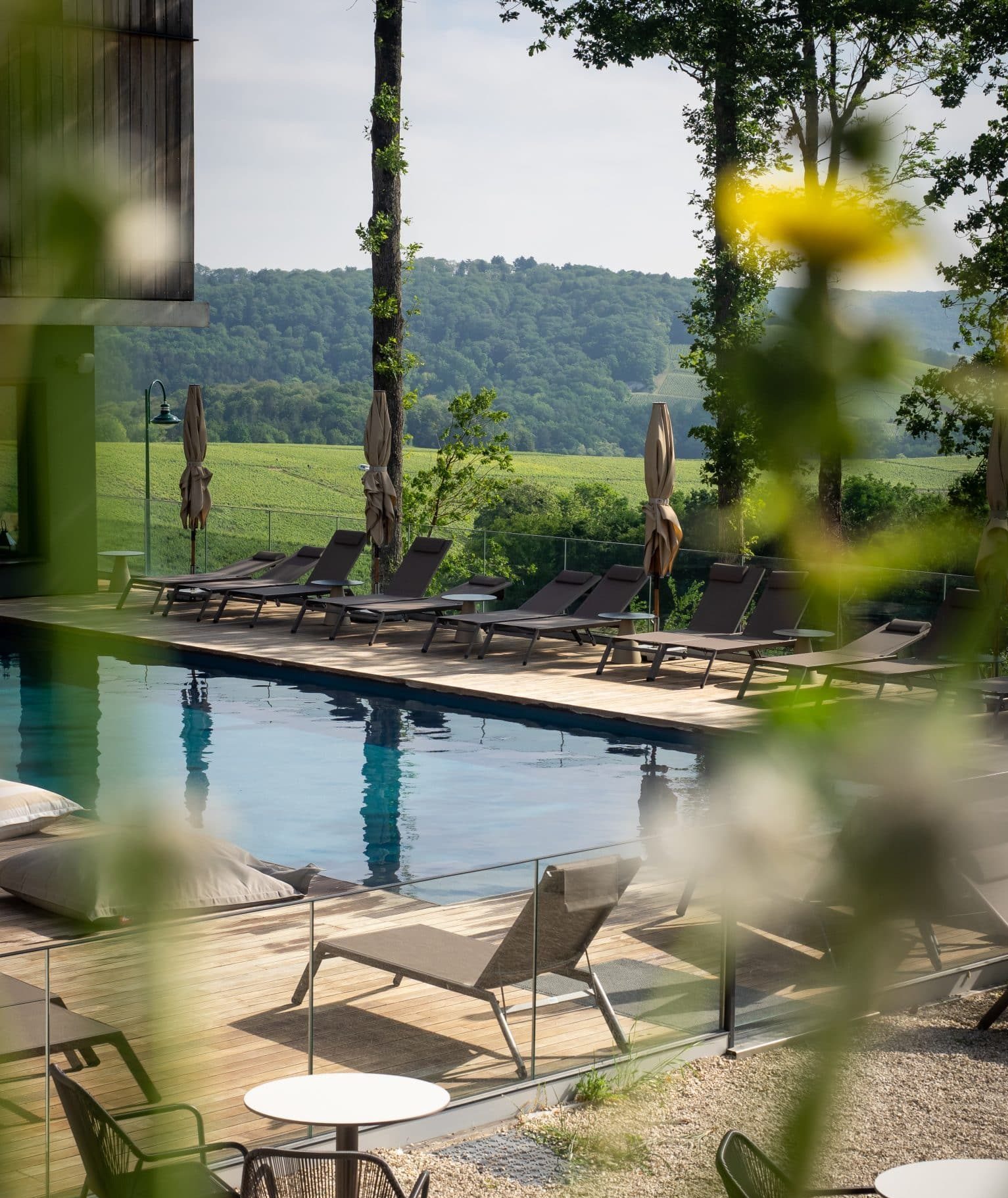 View of the pool and loungers at the LOSIUM Hotel Champagne in France.